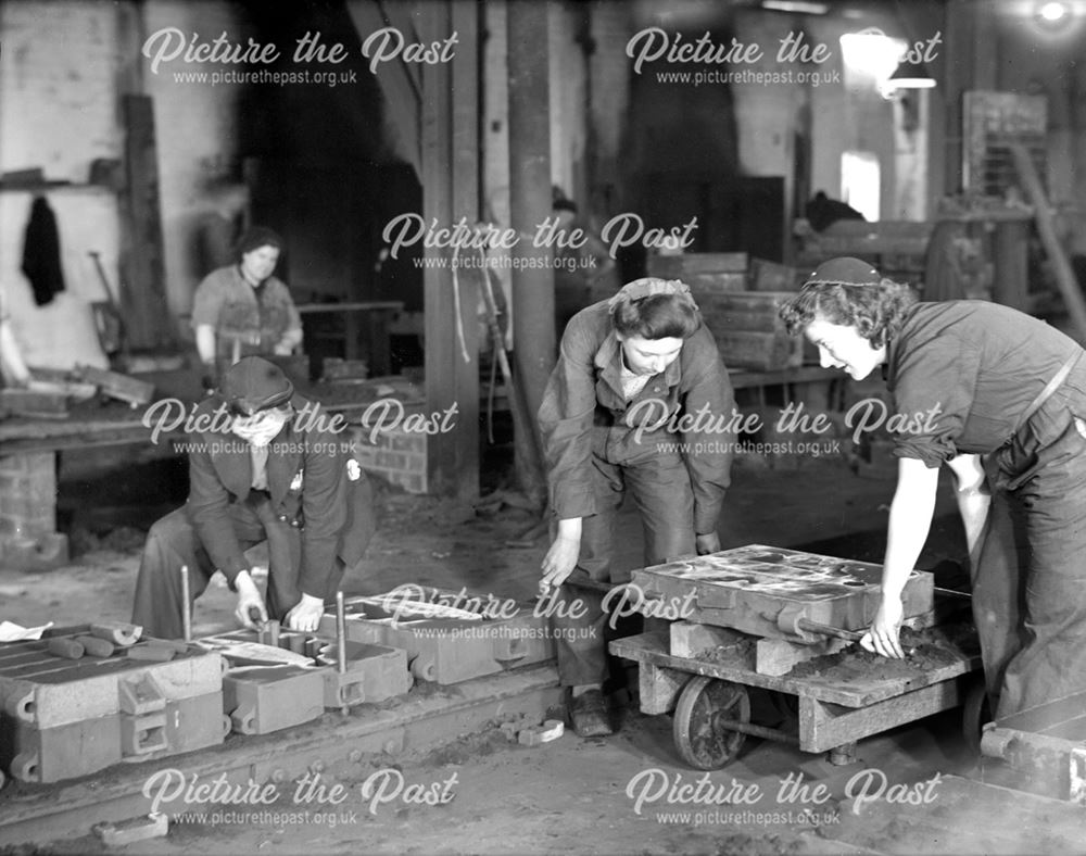 Female employees filling moulding boxes