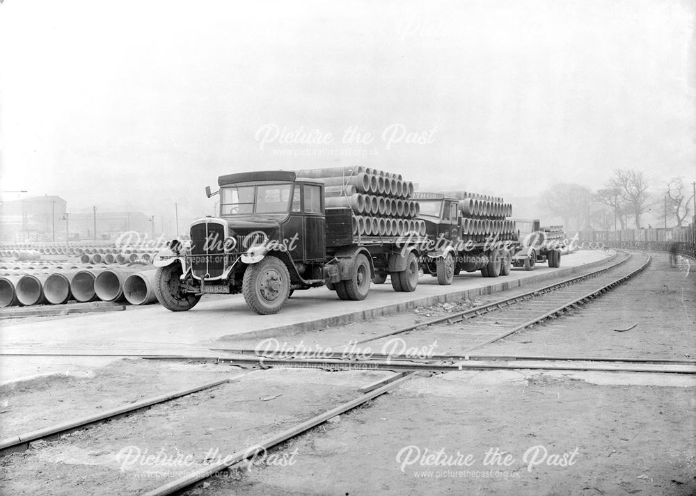 Lorries loaded with concrete pipes