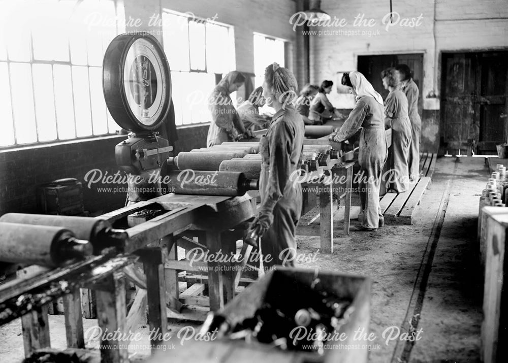 Female employees inspecting concrete practice rocket heads during World War 2 at Stanton Ironworks