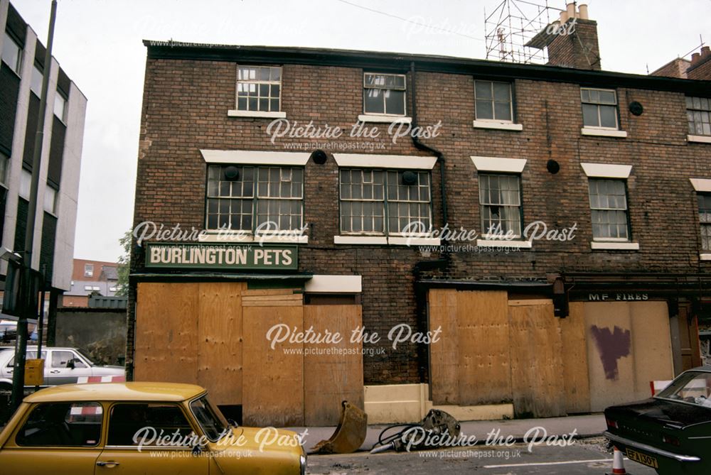 Georgian terrace of shops adjacent to The Buck in the Park public house