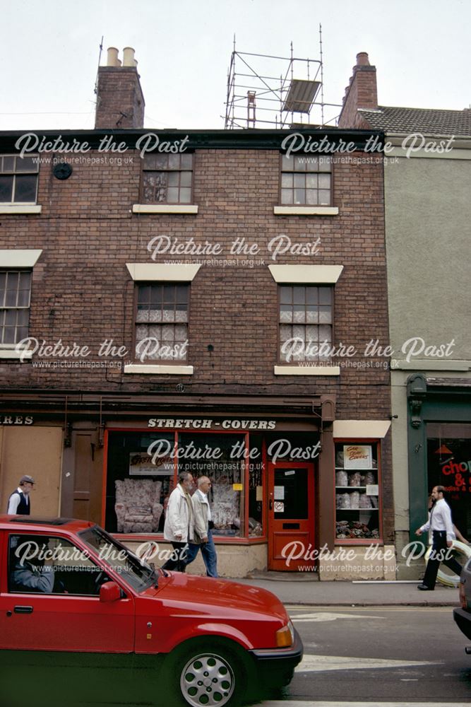 Georgian terrace of shops adjacent to The Buck in the Park public house