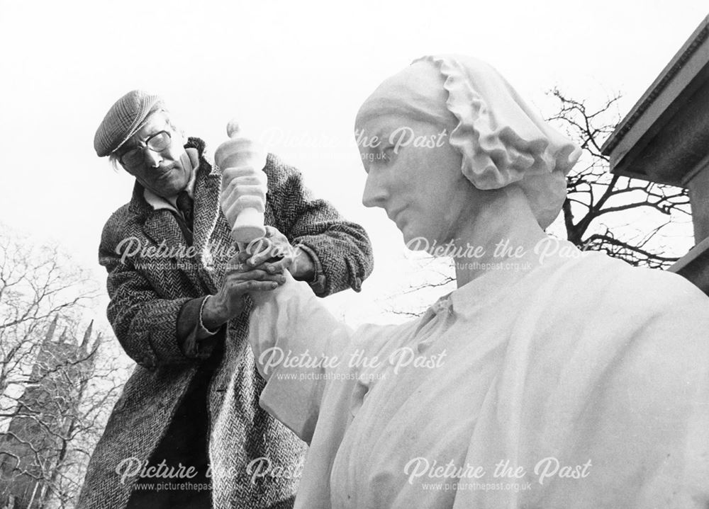 Mr Shaw, stonemason, attaches a new hand to the Florence Nightingale statue