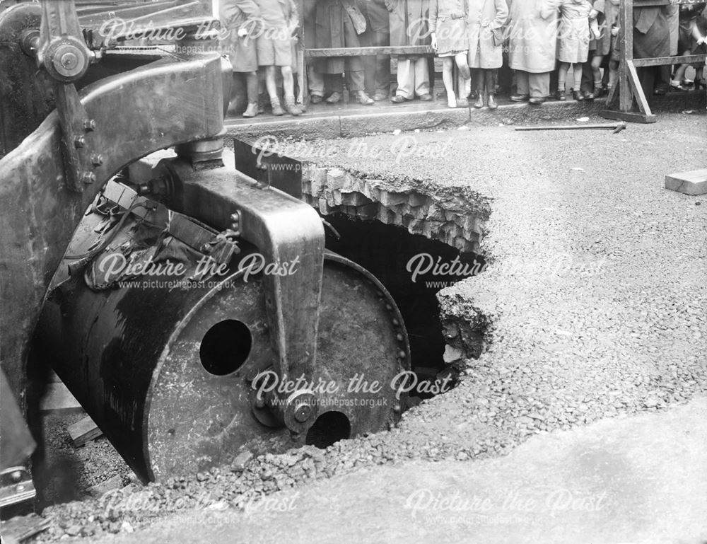 Steam Roller which has fallen through the road