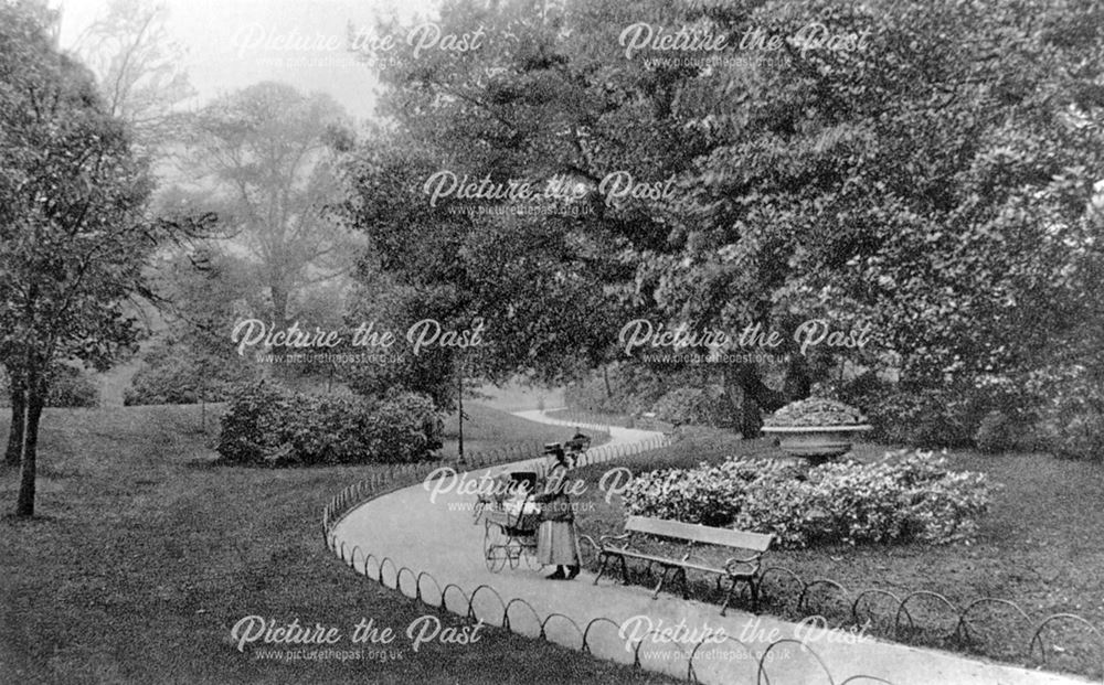 Woman with a pram on a path in the Arboretum, Derby