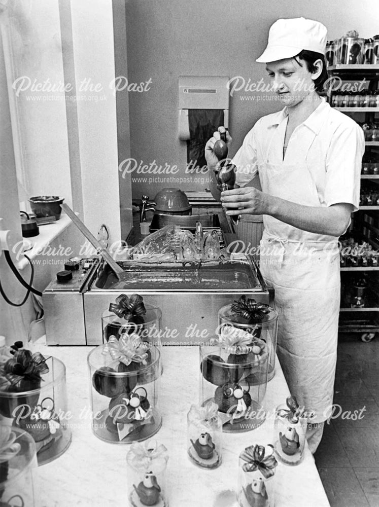 Worker making chocolate easter chicks and bunnies at Birds Confectioners (Derby) Ltd