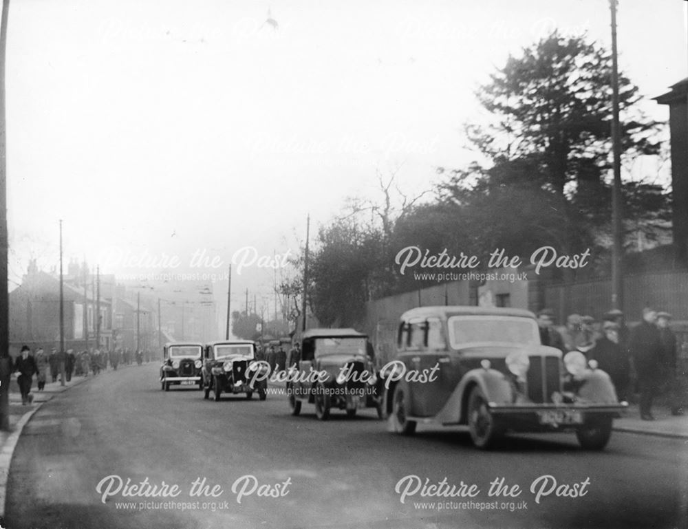 Cars and workers crowd the street on Osmaston Road