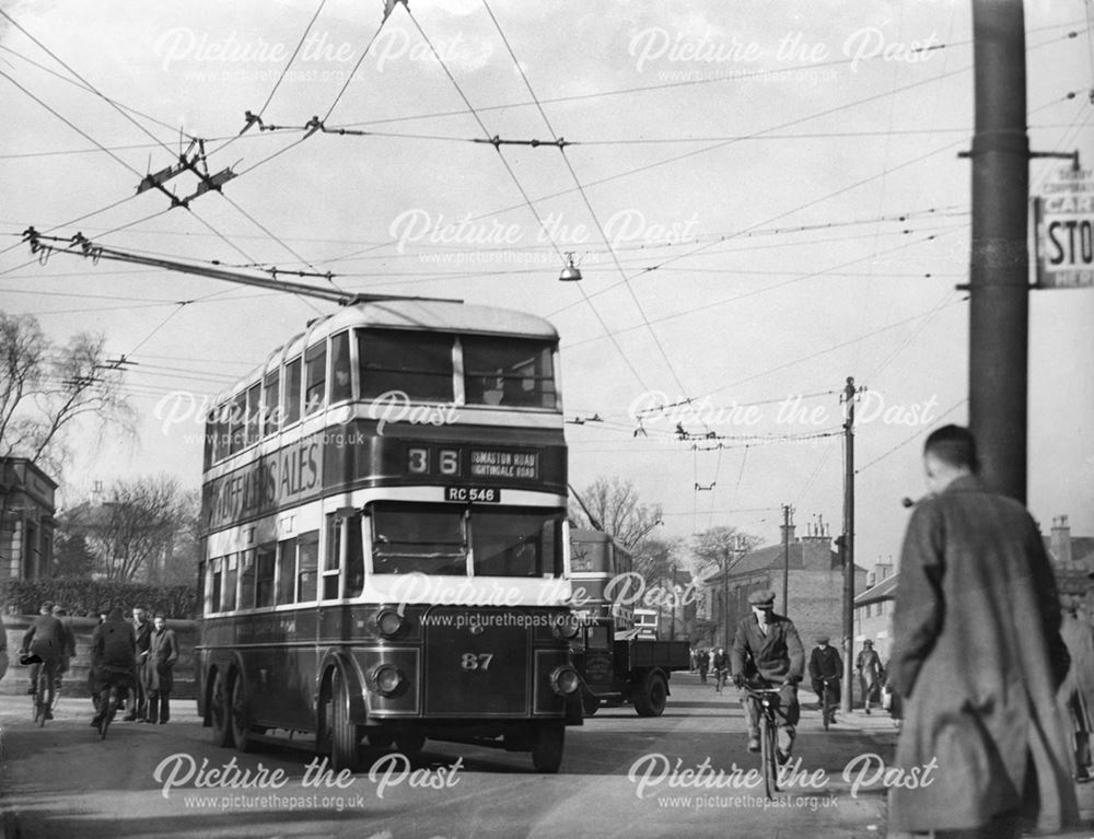 Traffic congestion, trolley buses and workers crowd the street on Osmaston Road