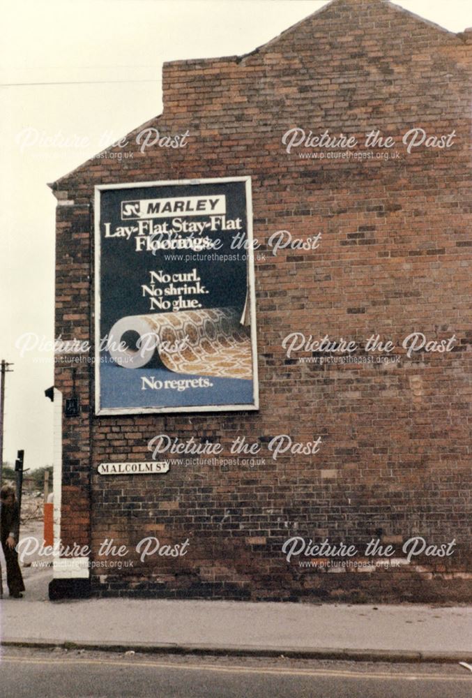 Advertisement board on the side of a shop on Malcolm Street - Alexandra Street corner