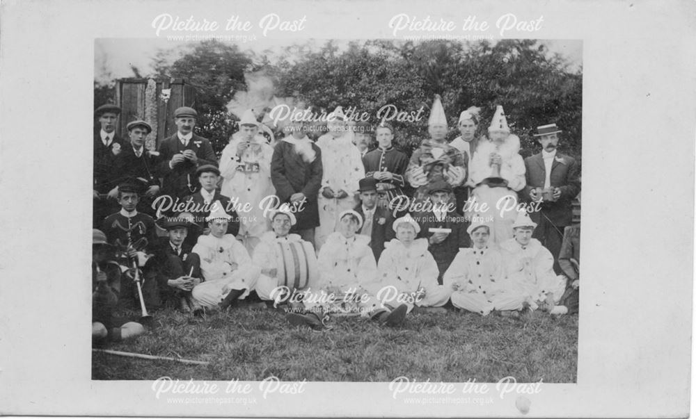 Group of adults in fancy dress mostly pierrot