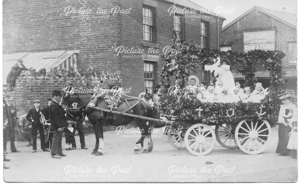 Decorated float, horse and cart with children