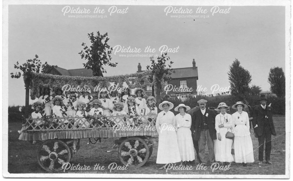 Girls on decorated cart for carnival