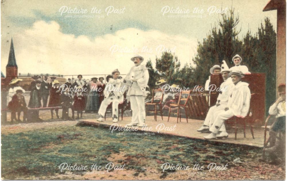 6 male Pierrot performing outdoors