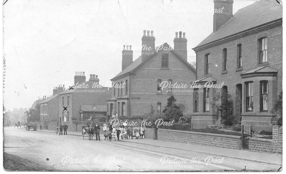 Street scene, group of people, horses and carts visible