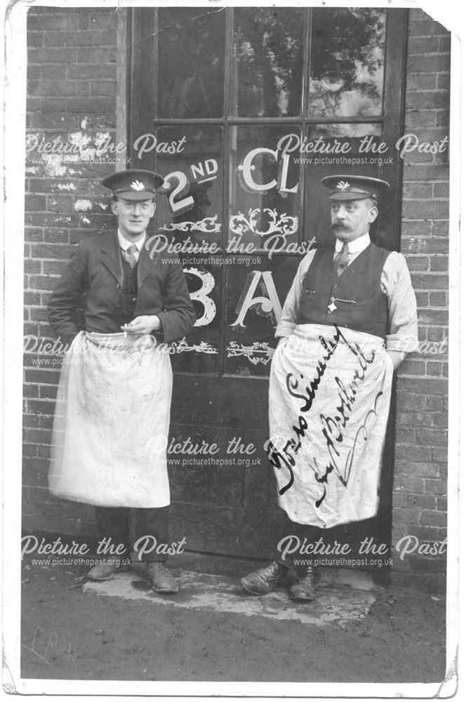 Two men standing in a shop doorway