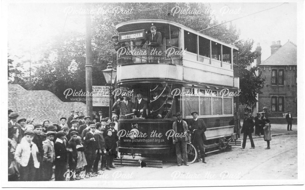 Double decker Nottingham tram, with crowd of children outside