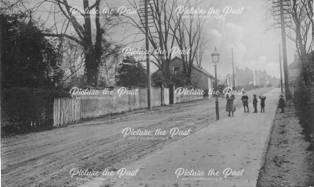 a snowy road with telegraph poles and youngsters