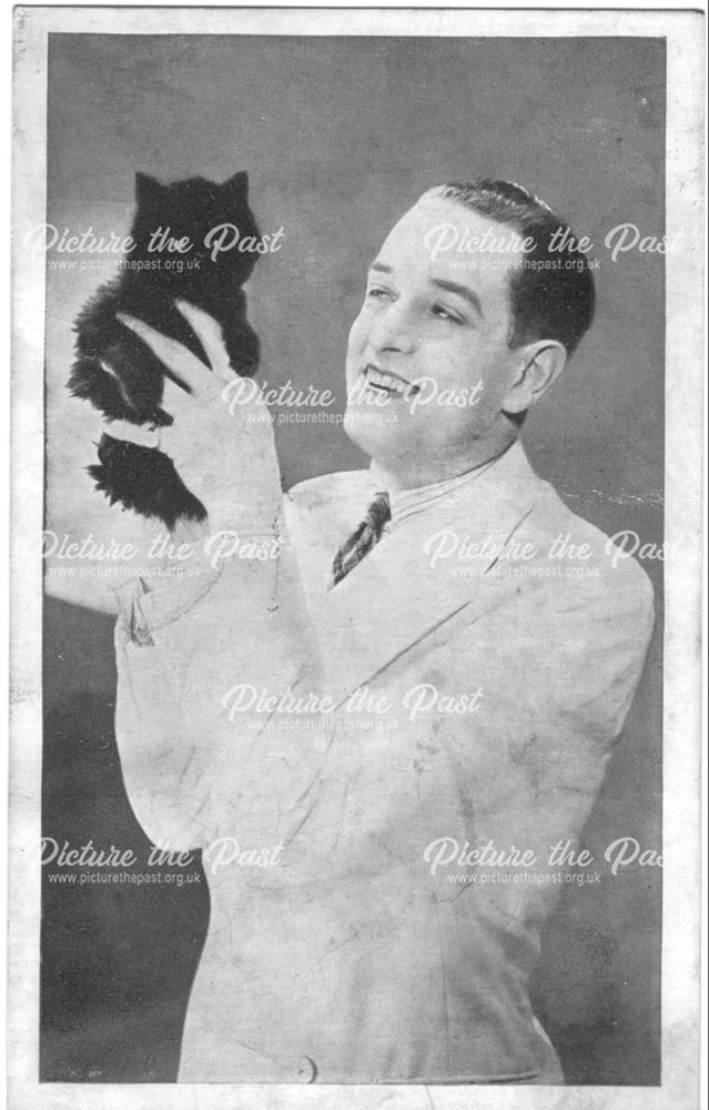 gentleman holding a young cat