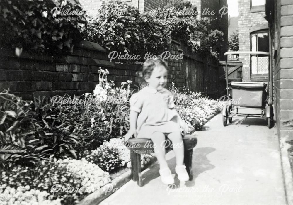 Girl in Garden with Pram, c 1930s-40s