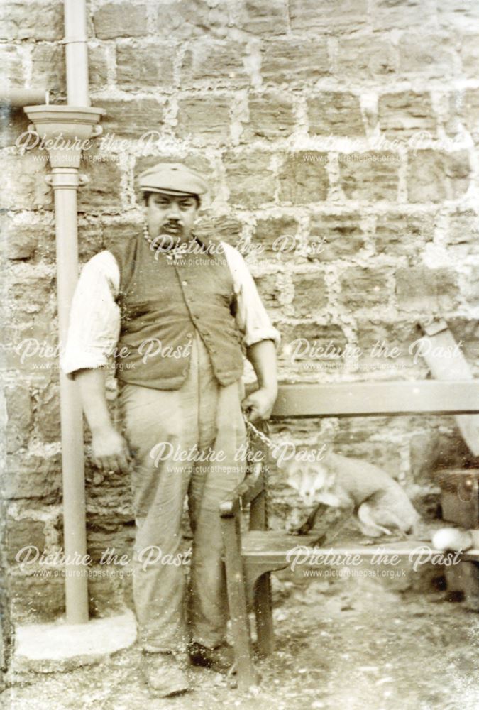 Landlord of the Half Moon Pub with his pet fox, Main Road, Whitwell, c1920's