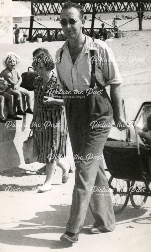 Eric Johnson from Bolsover pulling his daughter Eileen in pram, Skegness, Lincolnshire, 1946