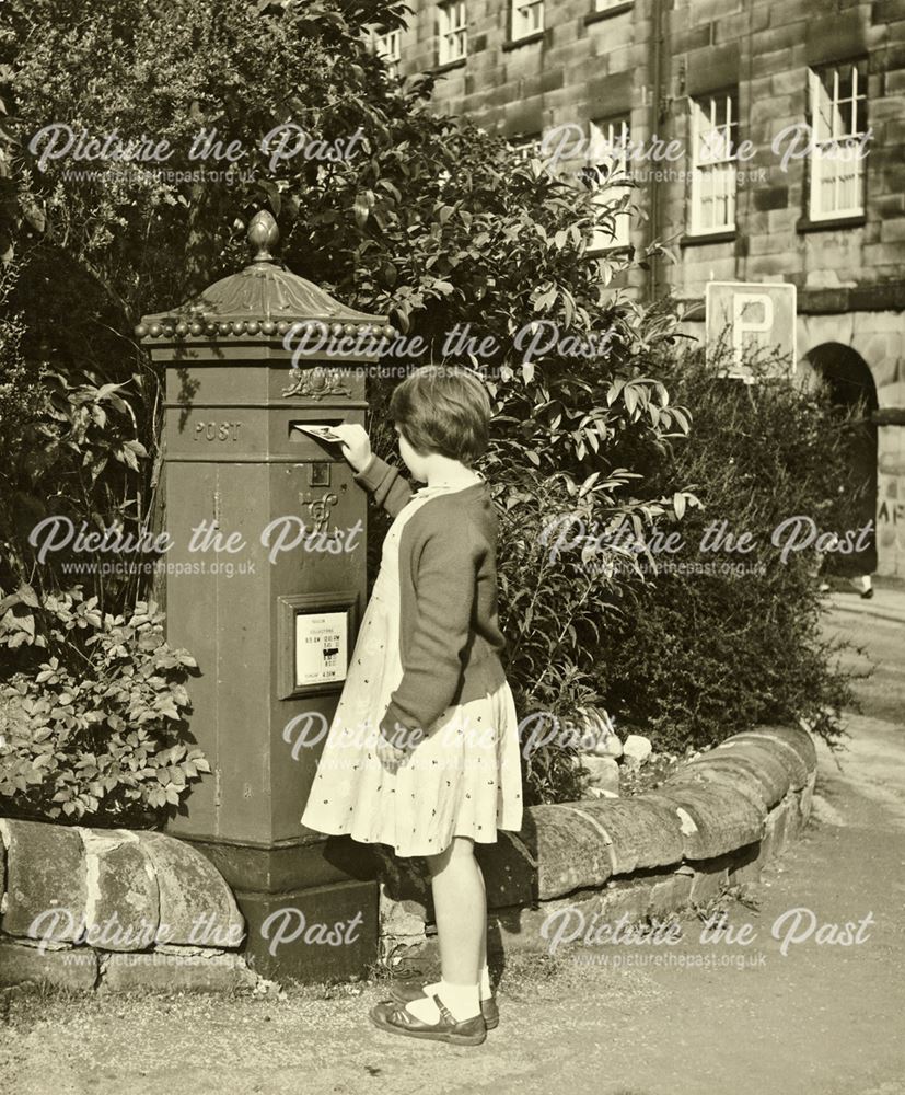 Girl posting letter in pillarbox near The Square
