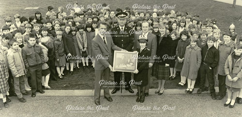 Presentation of framed photograph of Chief Constable Parrish by Dave Gibbs to school girl, Derby, c 