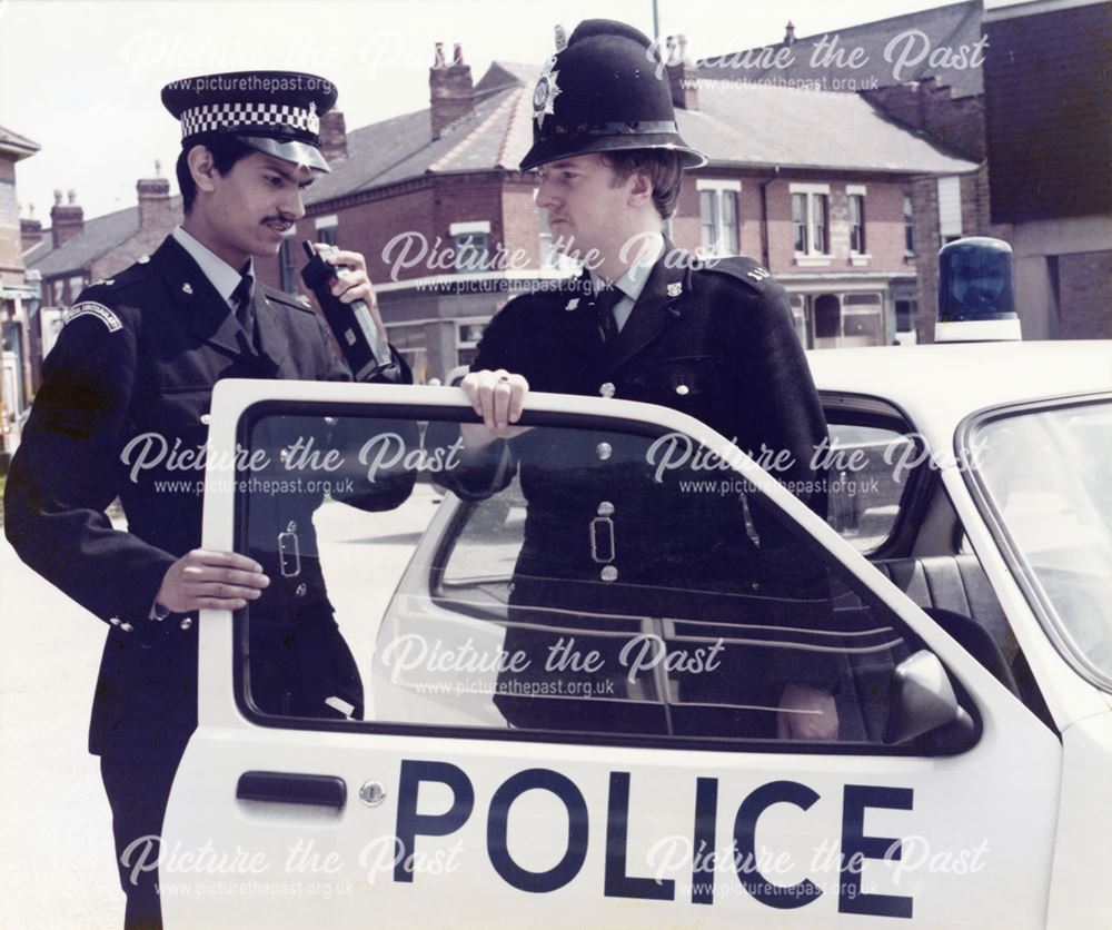 Derbyshire Constabulary Special Constable and Police constable 117 using radio and stood by police c
