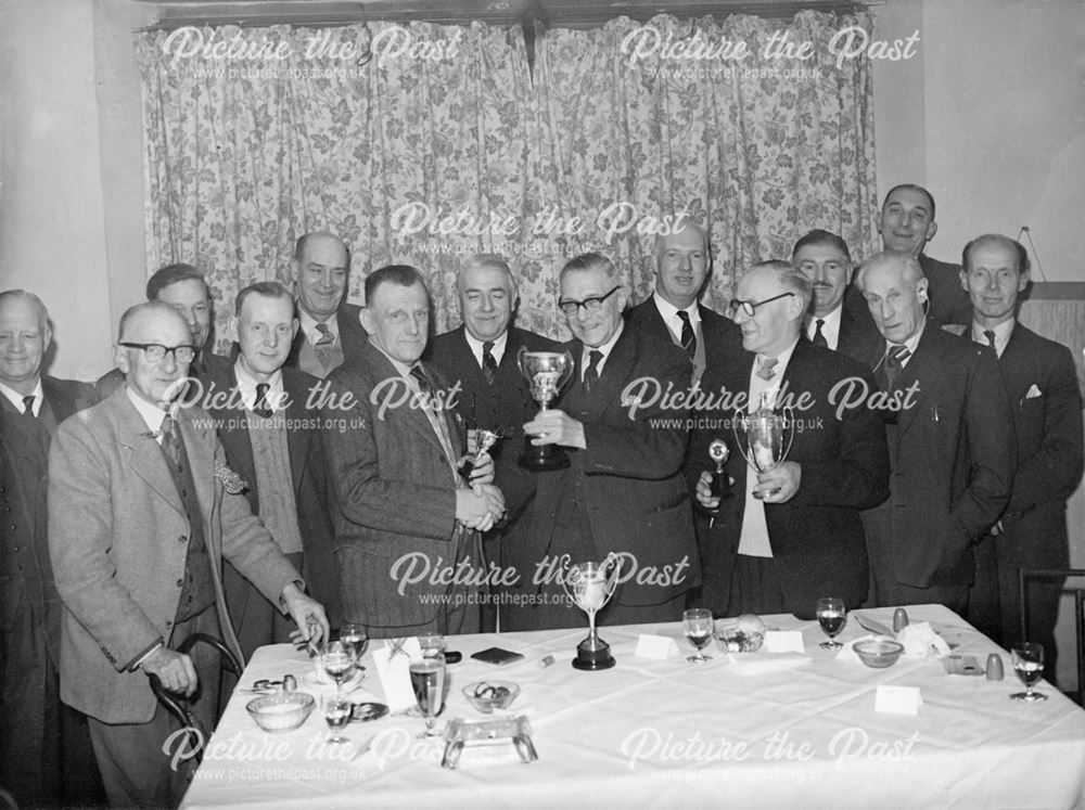 Mr William Lee being presented with a cup.