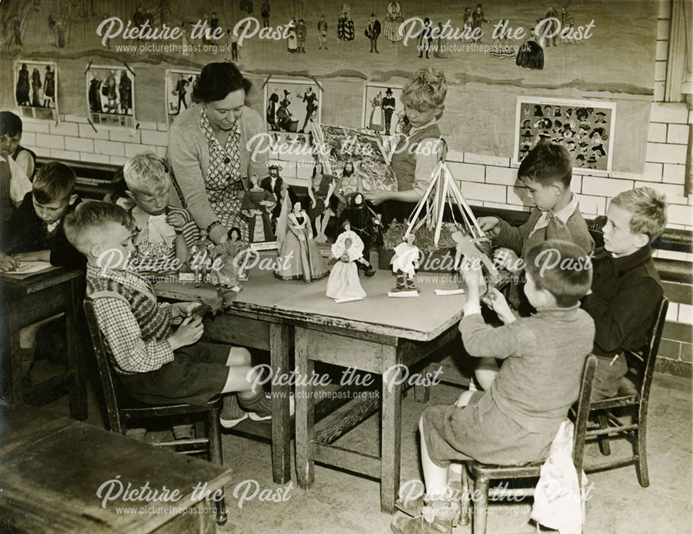 Maggie Moore (ne Mansfield) teaches children with tudor dolls, Shirebrook