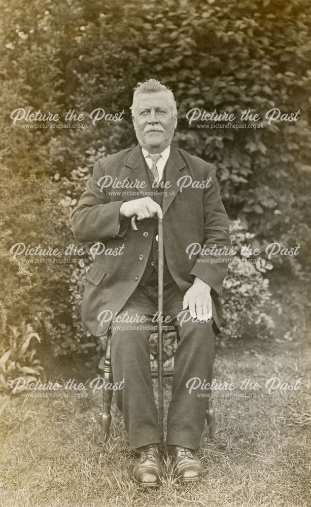 Unidentified man, seated with cane