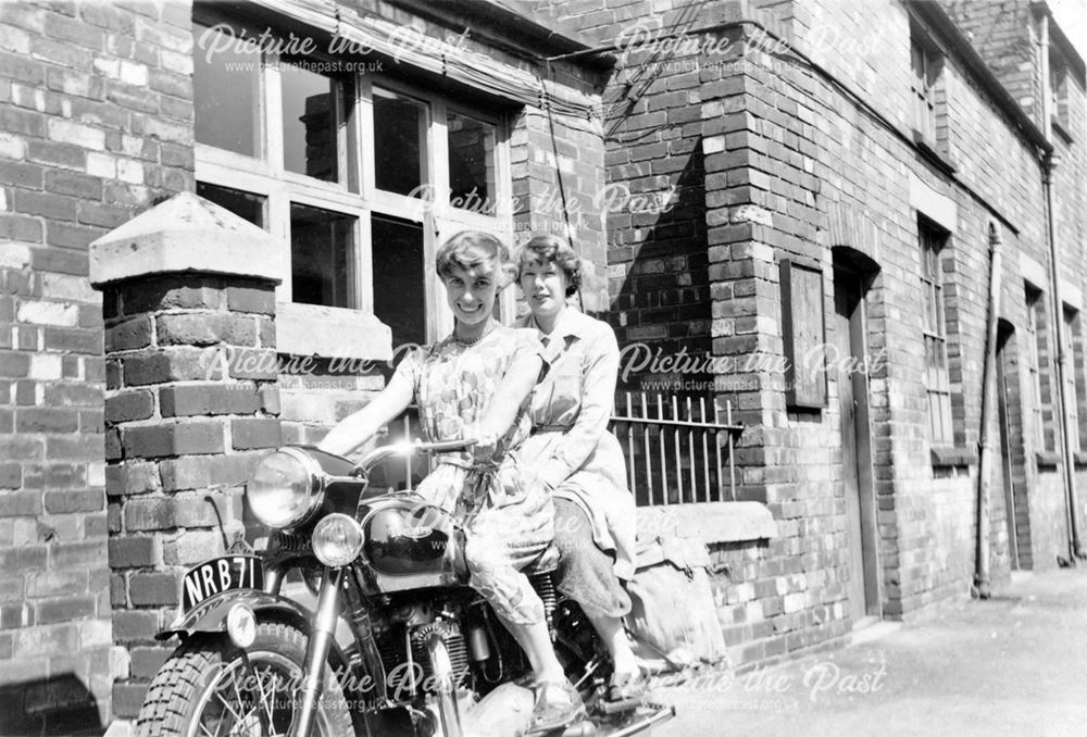 Two women on a motorbike