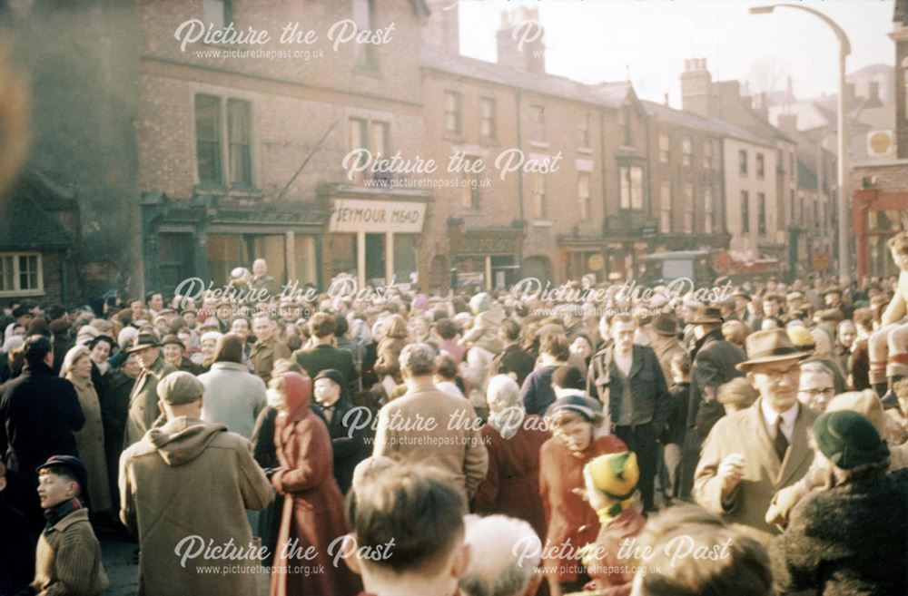 Shrovetide Football Game: The 'Thrower upper' is carried with the ball to Shaw Croft to start the ga