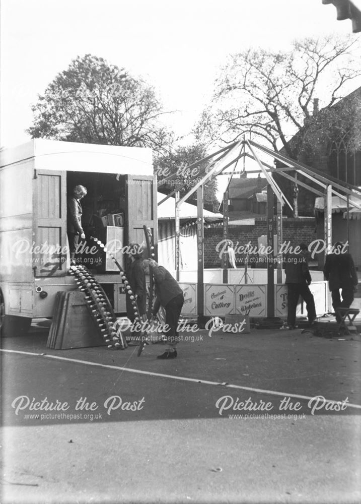 Ilkeston Fair - Showmen and women erecting a sideshow at the NE corner of the Market Place, outside 