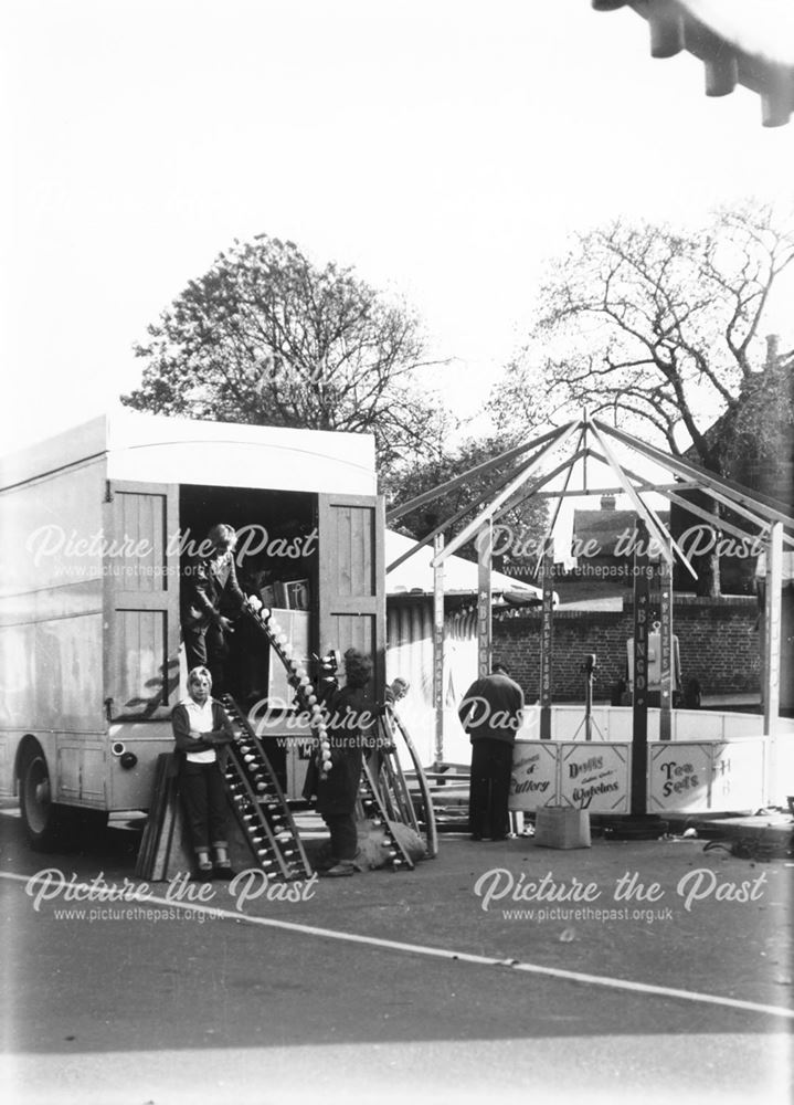 Ilkeston Fair - Showmen and women erecting a sideshow at the NE corner of the Market Place, outside 