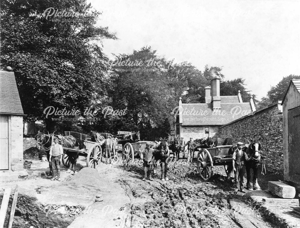 Workmen at the rear of the hall