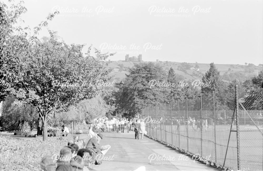 People enjoying Hall Leys Park, paths and tennis courts
