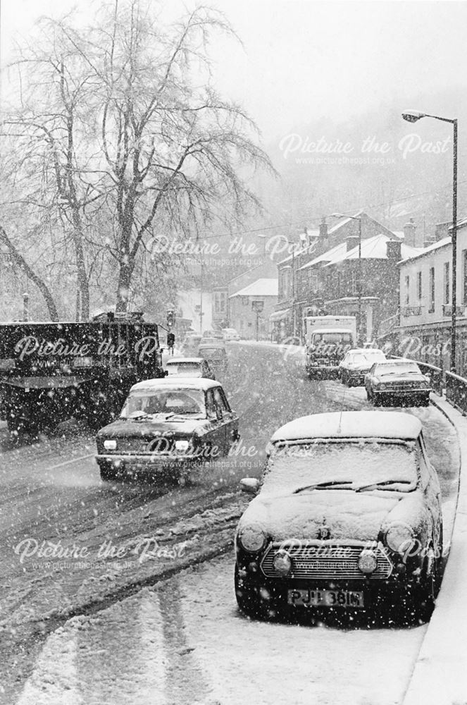 View of traffic through Matlock Bath in the snow