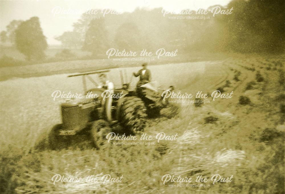 A tractor is cutting the sheaves during the corn harvest at Dale Bank Farm, Milltown (Near Ashover)