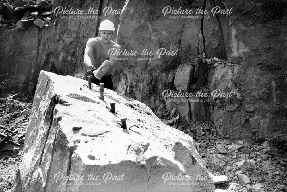 Quarryman splitting stone with 'plugs and feathers'