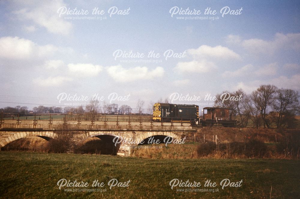 Engine and guards van going over the Bridge over the River Rother