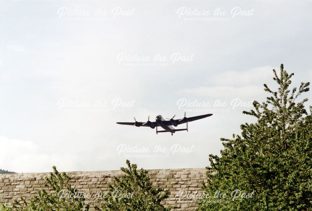 An Avro Lancaster makes a 'Dambusters' commemorative flight over Ladybower Reservoir's Derwent Dam
