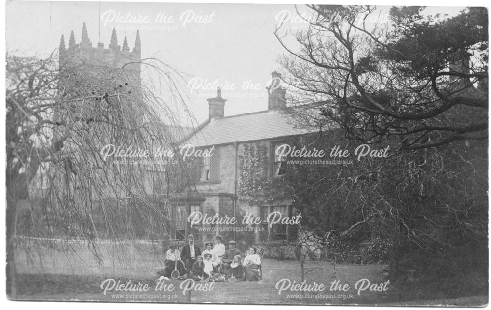 Group of people in garden with Morton Church behind