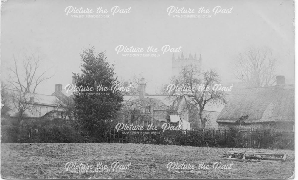 View of houses and church across fields