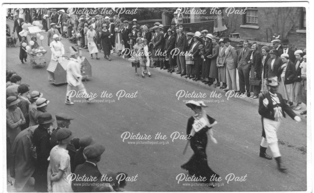 parade or carnival, watched by crowds