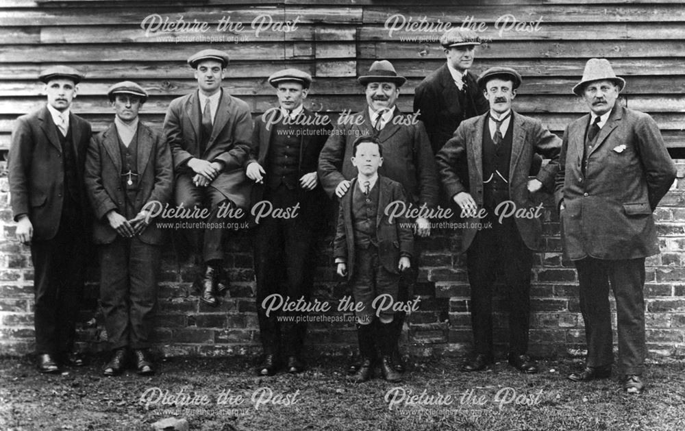 Group of men outside the cricket pavilion