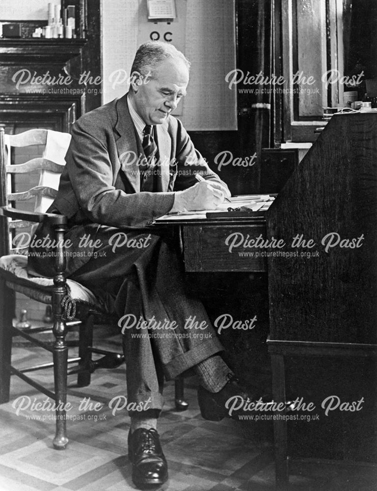 Dr George Clifton in his surgery at The Hall, High Street, Dronfield, c 1950s?