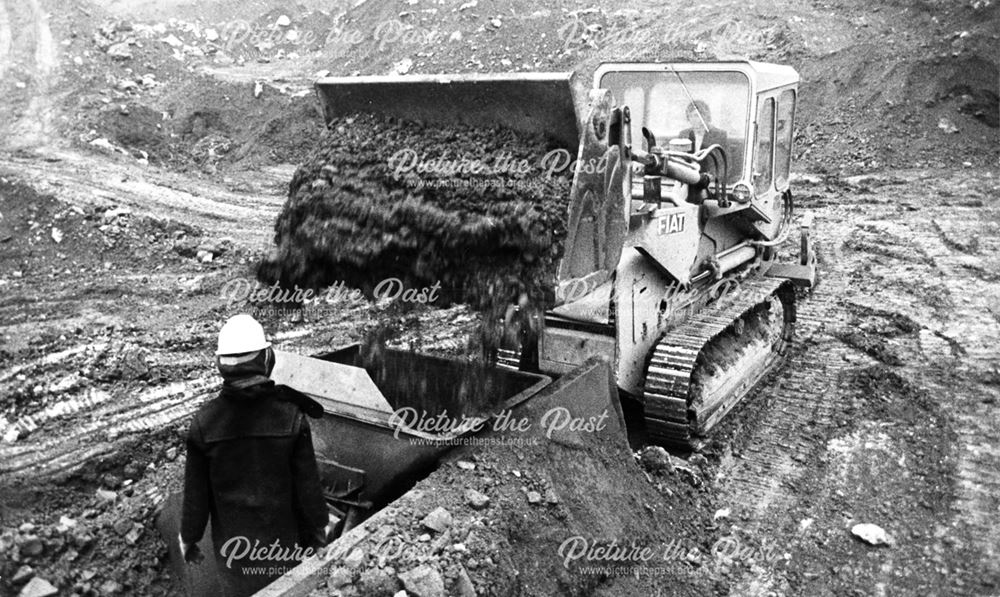 A Fiat bulldozer loading a 'rugger' or skip wagon at the clay pit at Chellaston Brick Works