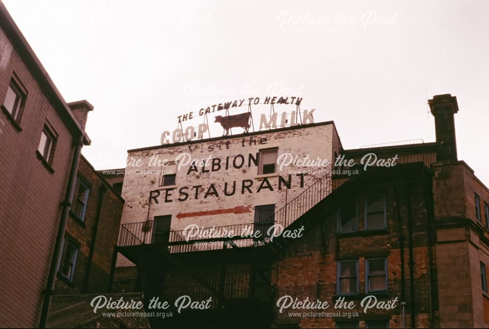 Sign for the Albion Restaurant, and the Co-op Milk Cow sign, East Street