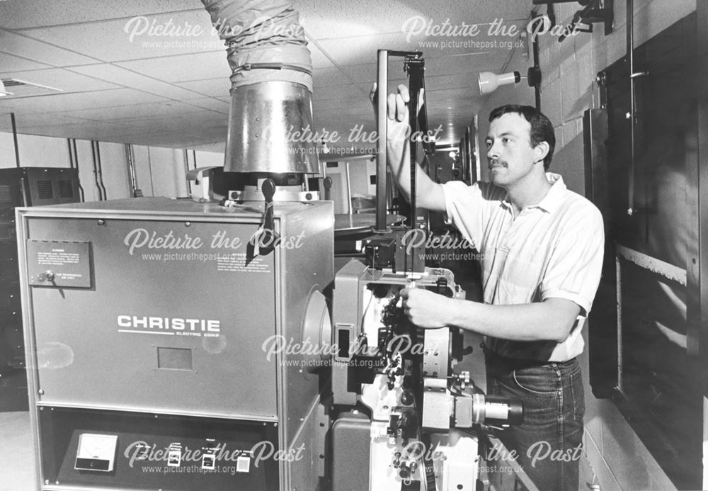 Showcase Cinema - Projectionist loading a reel of film