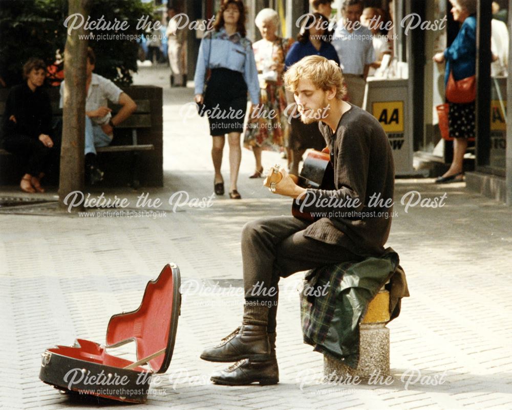 Busker with guitar